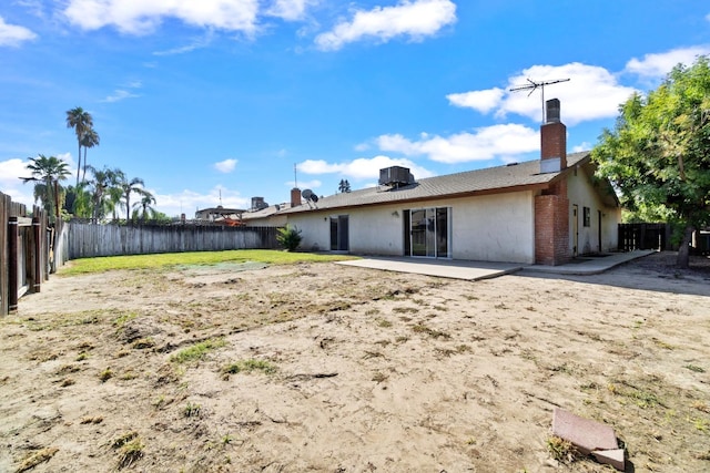 back of house with central air condition unit and a patio area