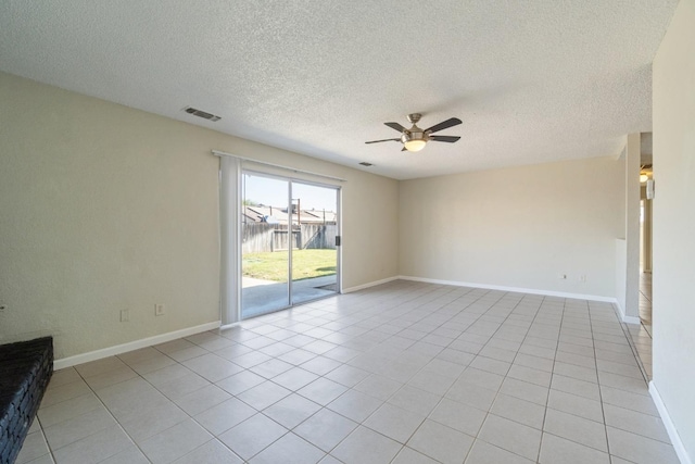 tiled empty room featuring a textured ceiling, ceiling fan, and a water view