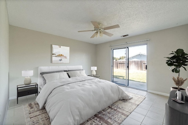 bedroom featuring ceiling fan, access to outside, light tile patterned flooring, and a textured ceiling