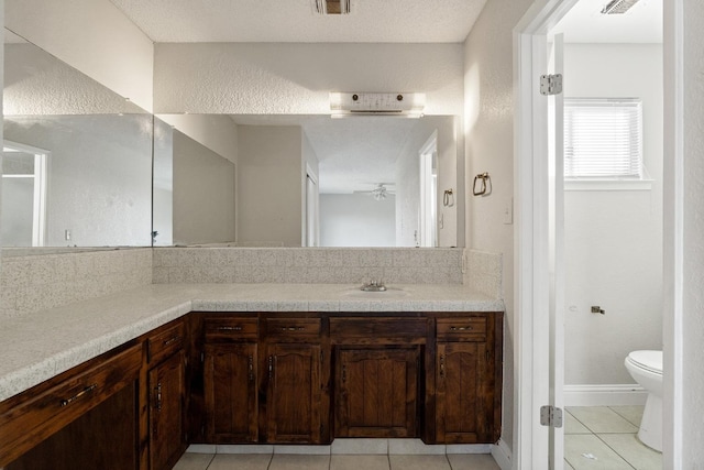 bathroom featuring vanity, tile patterned floors, and toilet