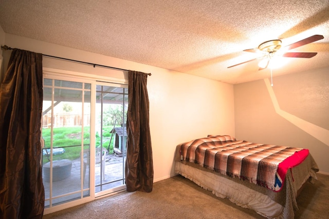 carpeted bedroom featuring access to exterior, a textured ceiling, and ceiling fan