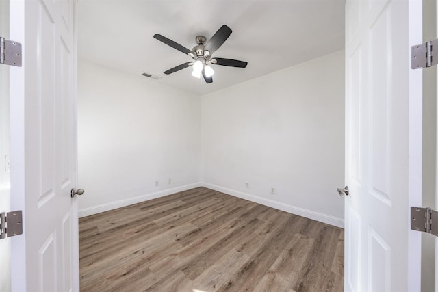 unfurnished room with ceiling fan and light wood-type flooring