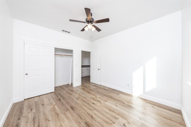 unfurnished bedroom with a closet, light hardwood / wood-style floors, and ceiling fan