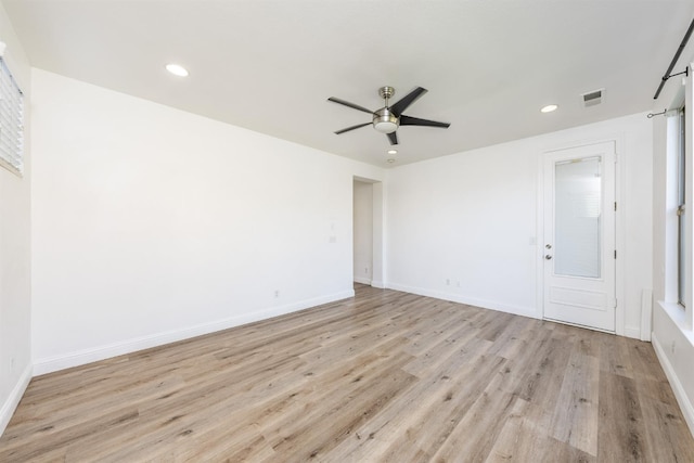 spare room with light wood-type flooring and ceiling fan