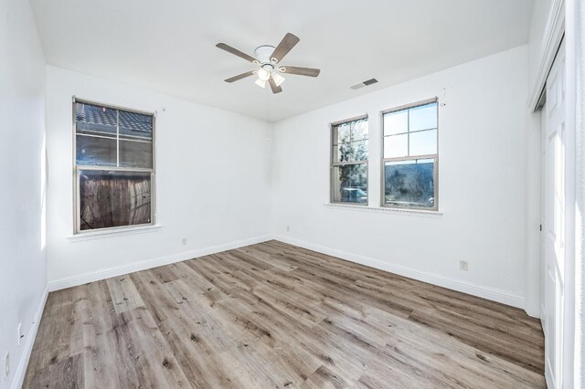 spare room with ceiling fan and light hardwood / wood-style floors