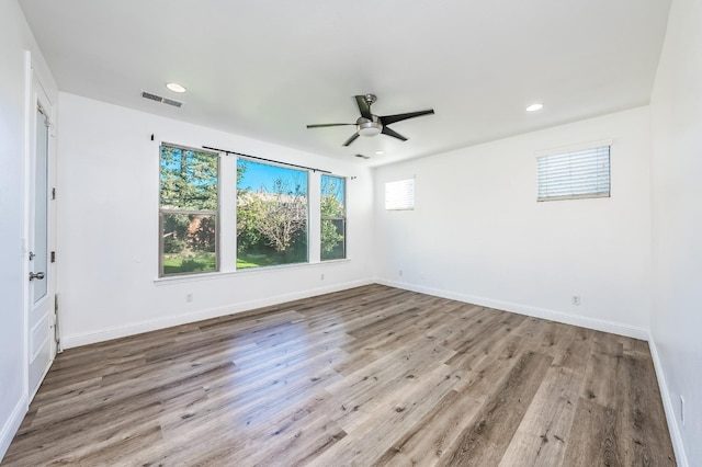 spare room with ceiling fan and light wood-type flooring