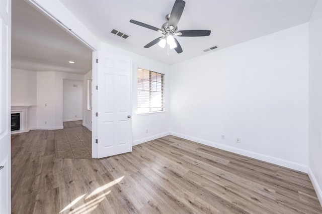 spare room featuring ceiling fan and light wood-type flooring