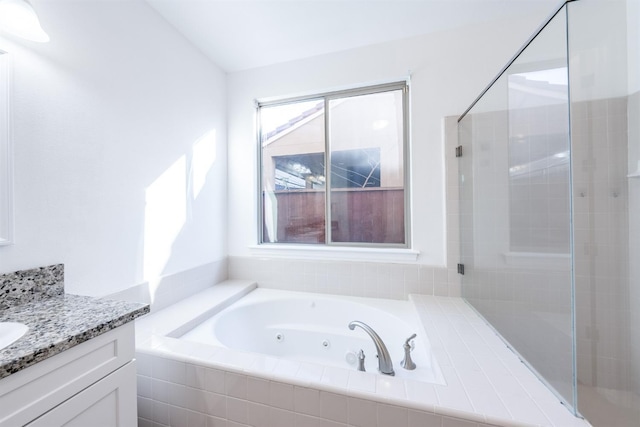 bathroom with plus walk in shower and vanity