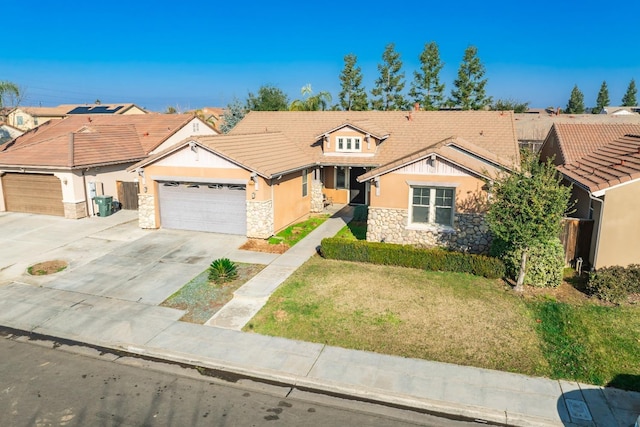 view of front of property with a front yard and a garage