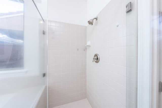 bathroom with tiled shower