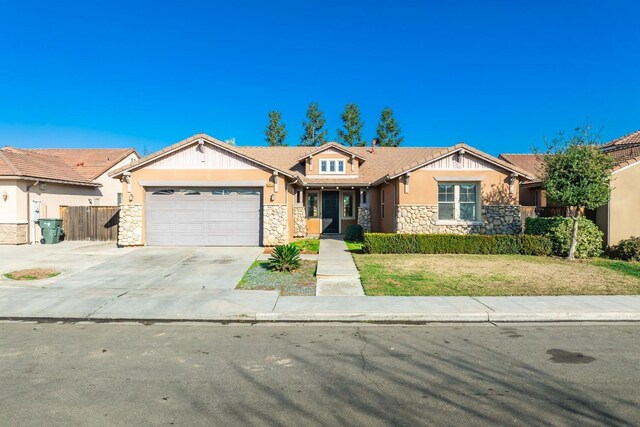 view of front of home with a front lawn and a garage