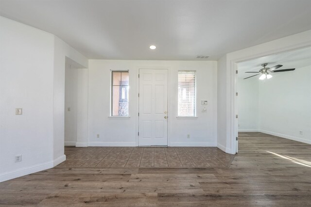 entryway with ceiling fan and dark wood-type flooring