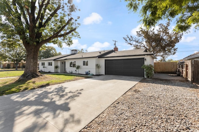 ranch-style house featuring a front yard and a garage