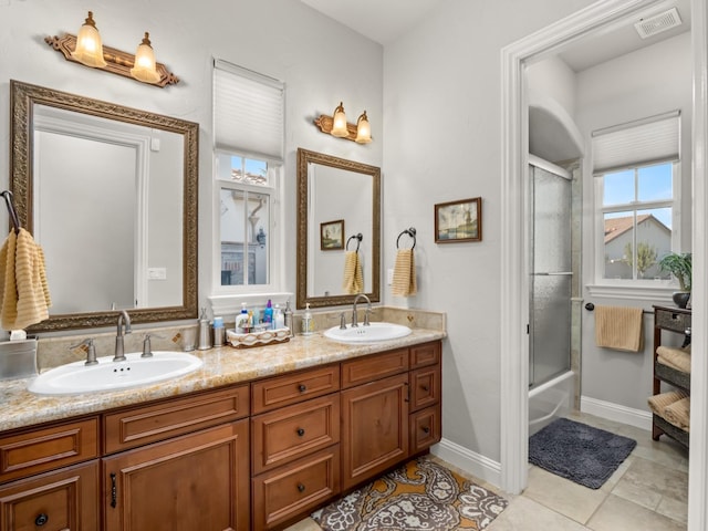 bathroom featuring shower / bath combination with glass door, vanity, and tile patterned flooring