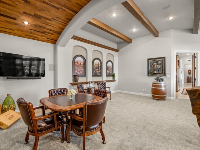 carpeted dining space with beam ceiling and wood ceiling