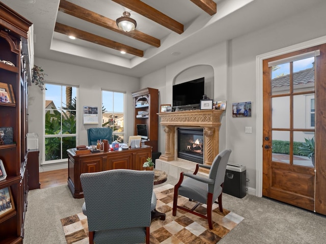 living room featuring a wealth of natural light, light carpet, and a tile fireplace