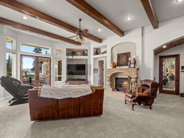 living room with light carpet, a high ceiling, and ceiling fan