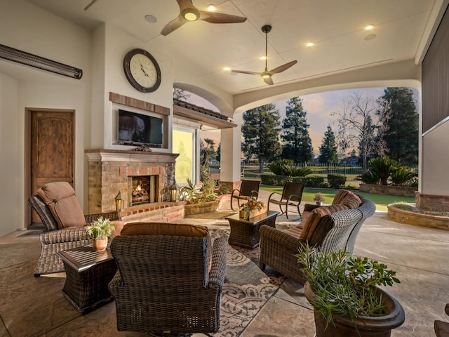 view of patio / terrace featuring an outdoor living space with a fireplace and ceiling fan