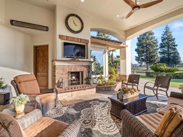 view of patio featuring an outdoor living space with a fireplace and ceiling fan