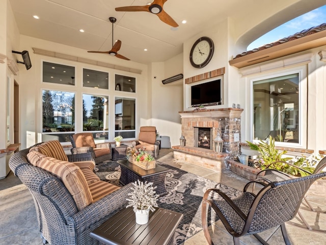 view of patio / terrace featuring an outdoor living space with a fireplace and ceiling fan