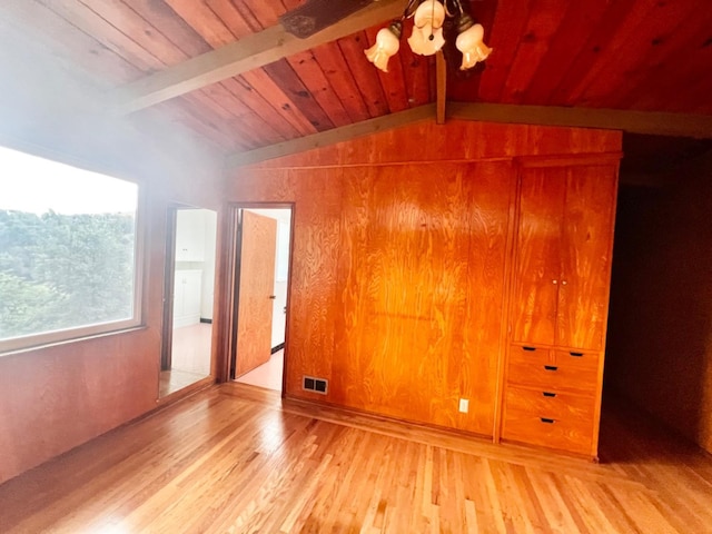 interior space featuring vaulted ceiling with beams, wood ceiling, and hardwood / wood-style floors