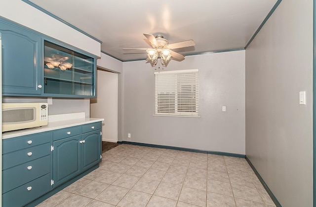 interior space with ceiling fan and light tile patterned flooring