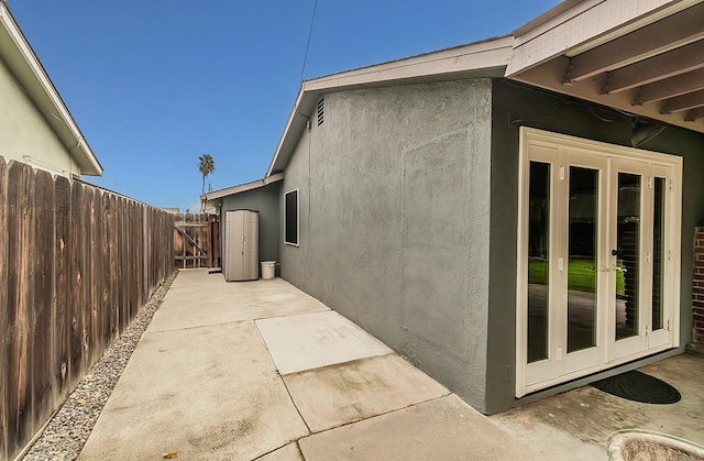 view of home's exterior with a patio area and french doors