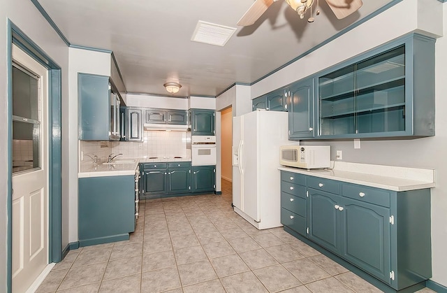 kitchen featuring sink, white appliances, ceiling fan, light tile patterned flooring, and decorative backsplash