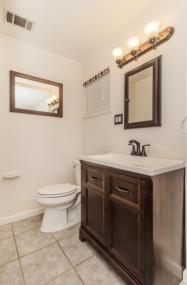 bathroom featuring vanity, toilet, and tile patterned floors