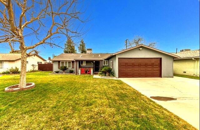 single story home with a garage and a front lawn