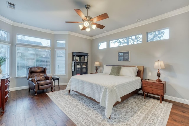 bedroom with ceiling fan, ornamental molding, and dark wood-type flooring