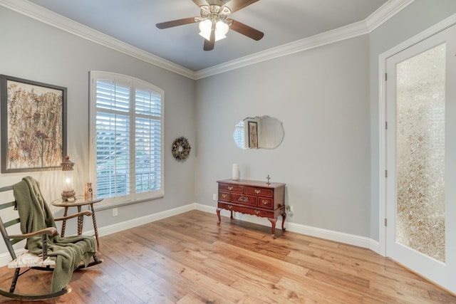 sitting room with a healthy amount of sunlight, ceiling fan, and ornamental molding