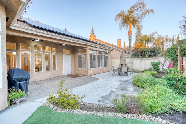 back of house featuring solar panels and a patio area