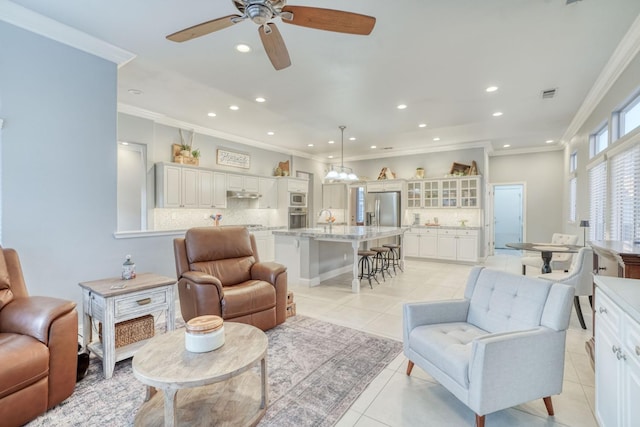 living room with ceiling fan, sink, light tile patterned floors, and crown molding