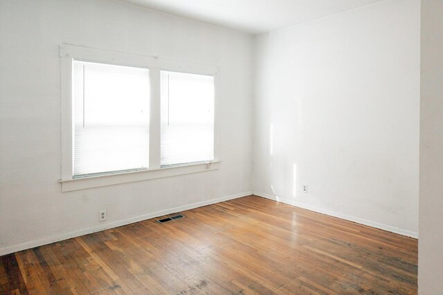 empty room with wood-type flooring