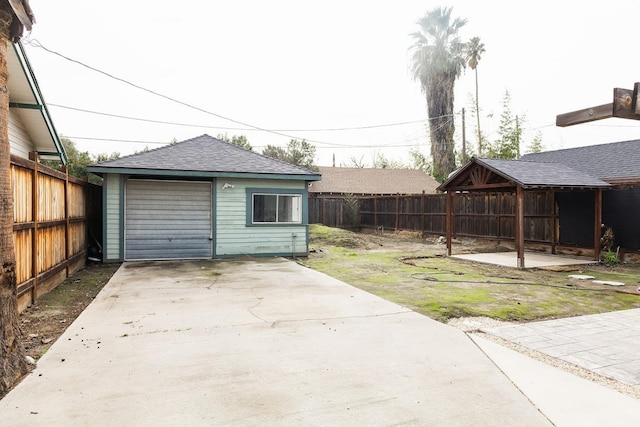 view of yard featuring a patio, an outdoor structure, and a garage