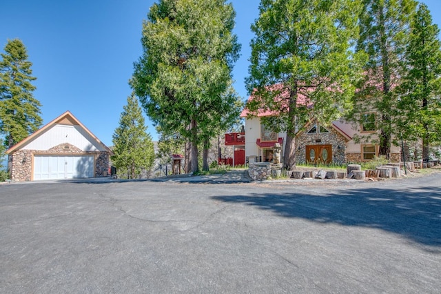 39722 Crest Point Ln, Shaver Lake, CA 93664 - view of front of home with stone siding and a detached garage
