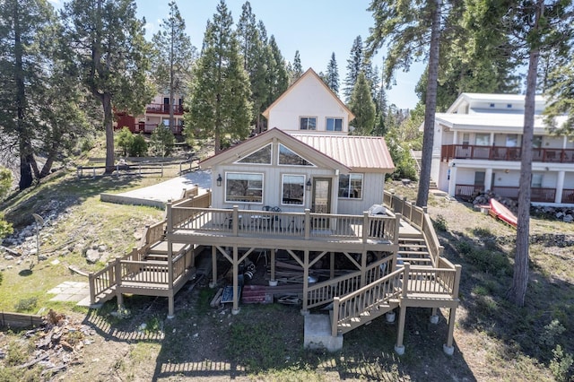 39722 Crest Point Ln, Shaver Lake, CA 93664 - rear view of property featuring stairway, a deck, and metal roof