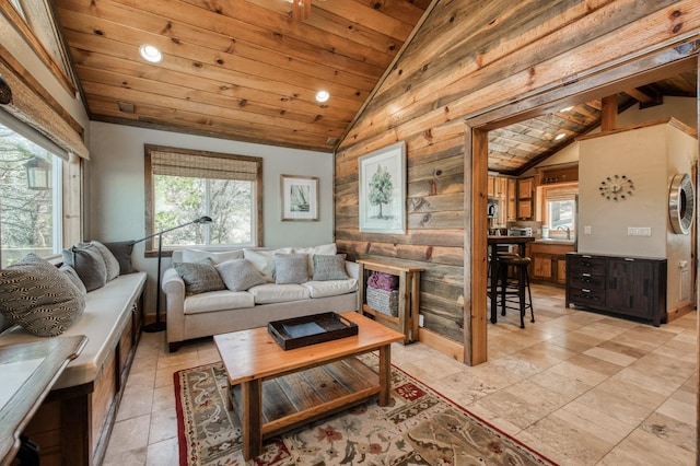 living room featuring wood ceiling, sink, wooden walls, and vaulted ceiling