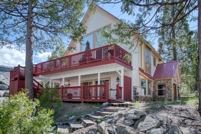39722 Crest Point Ln, Shaver Lake, CA 93664 - back of house with stone siding and metal roof