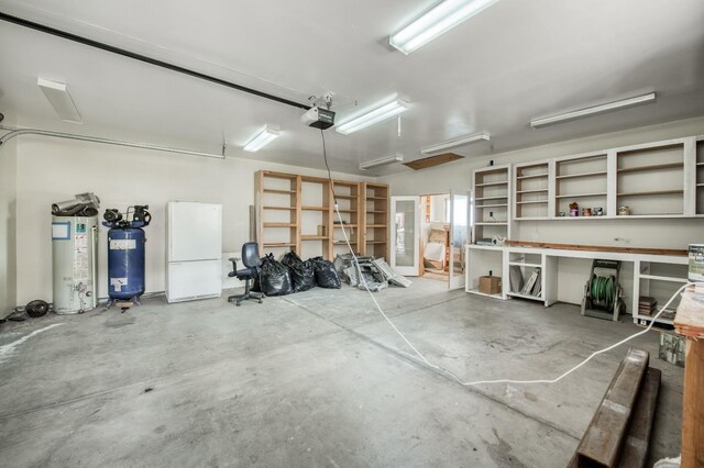 39722 Crest Point Ln, Shaver Lake, CA 93664 - garage featuring a garage door opener, freestanding refrigerator, and gas water heater