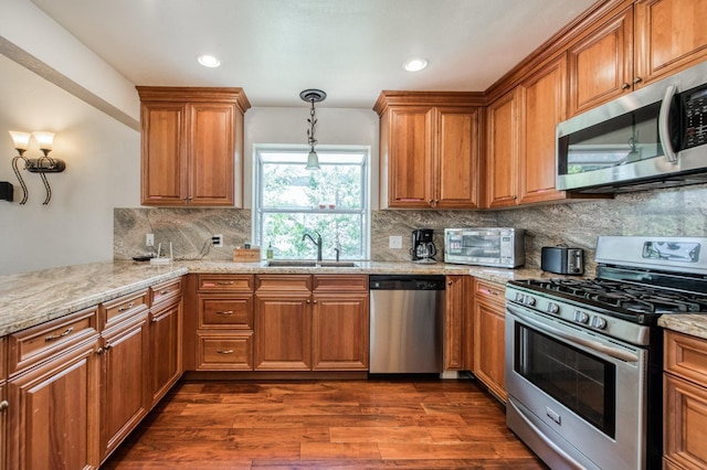 39722 Crest Point Ln, Shaver Lake, CA 93664 - kitchen featuring stainless steel appliances, a sink, brown cabinets, decorative backsplash, and recessed lighting
