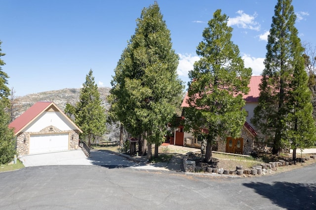 view of property hidden behind natural elements featuring a mountain view