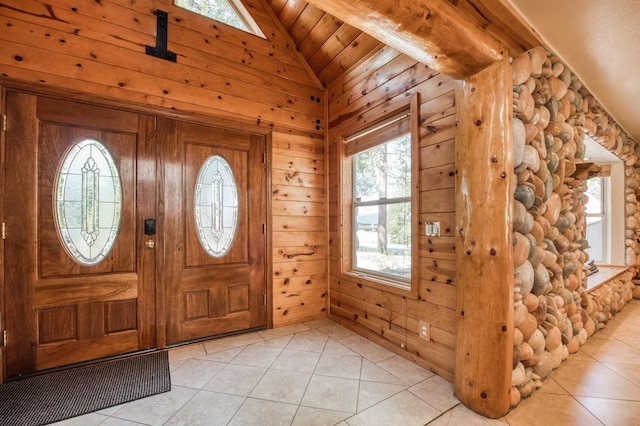 entrance foyer with light tile patterned floors, vaulted ceiling, wooden walls, and wood ceiling