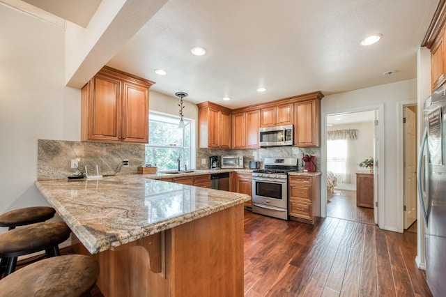 39722 Crest Point Ln, Shaver Lake, CA 93664 - kitchen with stainless steel appliances, a peninsula, plenty of natural light, backsplash, and recessed lighting