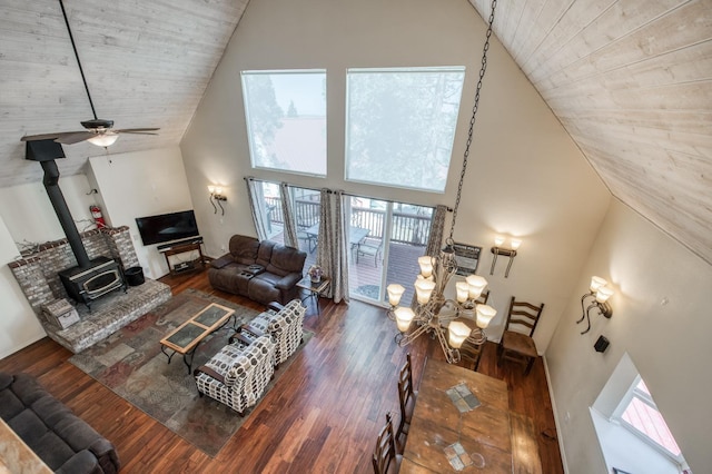 39722 Crest Point Ln, Shaver Lake, CA 93664 - living room featuring high vaulted ceiling, a wood stove, wood ceiling, wood finished floors, and a ceiling fan