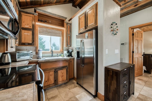 kitchen with sink, stainless steel fridge with ice dispenser, lofted ceiling with beams, wood ceiling, and range