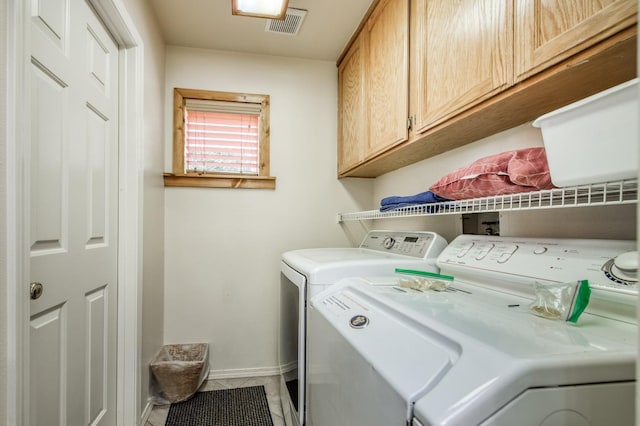 laundry room featuring tile patterned flooring, cabinets, and independent washer and dryer