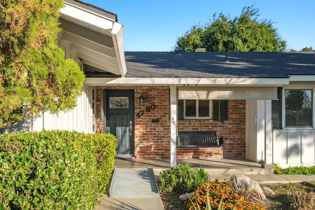 view of exterior entry with covered porch