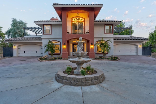 mediterranean / spanish home with a balcony and a garage